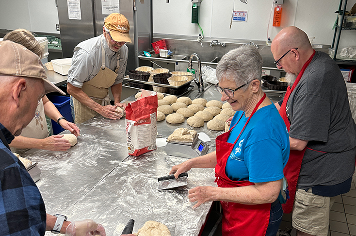 People making bread in a kitchen